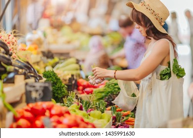 Woman Is Chooses  Fruits And Vegetables At Food Market. Reusable Eco Bag For Shopping. Zero Waste Concept.