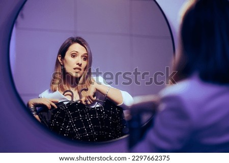
Woman Choosing Between Two Elegant Dresses for a Party. Lady trying to pick the best outfit for an important event 
