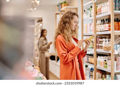 Woman choosing body cream in store - Powered by Shutterstock