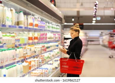 Woman Choosing A Dairy Products At Supermarket	