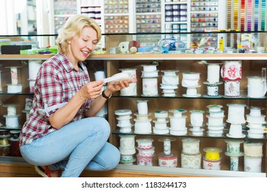 Woman Choosing Decorative Ribbon Or Band For Sewing Hobby At Craft Store