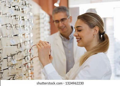 Woman Choosing Eyeglasses In Optic Store