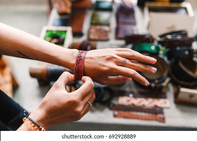Woman Choosing Leather Jewelry Bracelets At The Handmade Craft Market