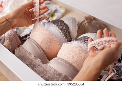 Woman choosing lingerie. Drawers filled with sexy lace lingerie. Textile, Underwear.