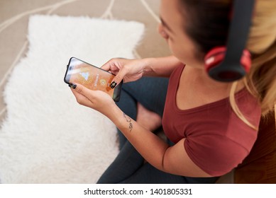 Woman Choosing Music For Meditation From Collection In Mobile App