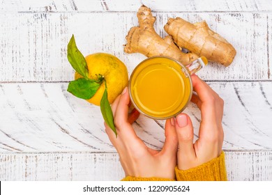 Woman is choosing natural healthy turmeric drink instead of traditional drugs and pills against flu. Alternative medicine concept. Top view, copy space