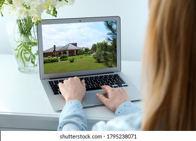 Woman choosing new house online using laptop or real estate agent working at table, closeup