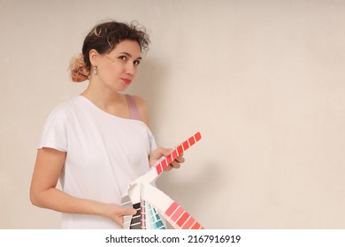 A Woman Choosing A Paint Color From A Sample For A Room