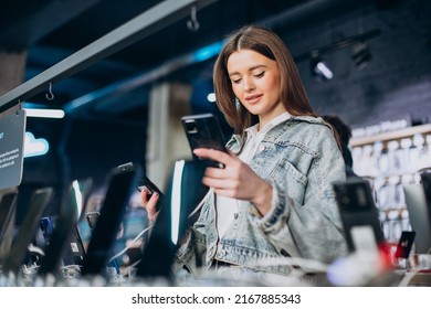 Woman Choosing Phone At Technology Store