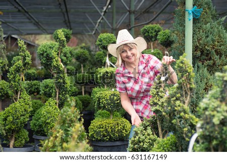 Woman choosing plants at nursery