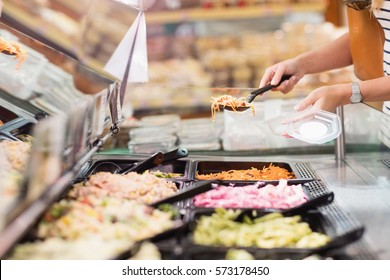 Woman Choosing Prepared Meal In Grocery Store