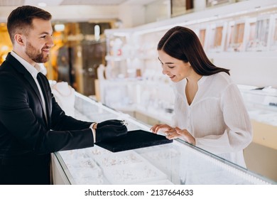 Woman choosing a ring at jewelry shop - Powered by Shutterstock