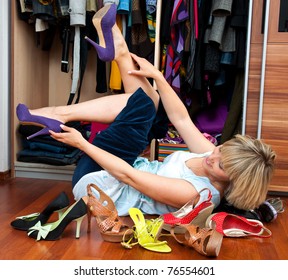 Woman Choosing Shoes In Front Of The Closet