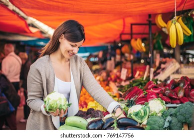 Woman Choosing Vegetables At The Market.