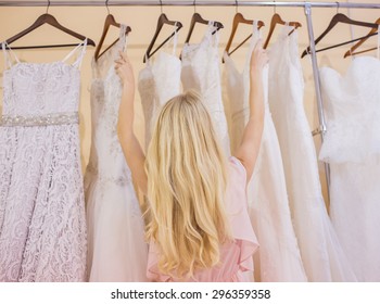 Woman Is Choosing A Wedding Dress In The Shop