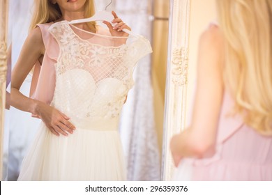 Woman Is Choosing A Wedding Dress In The Shop