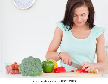 Woman Chopping Vegetables In Her Kitchen