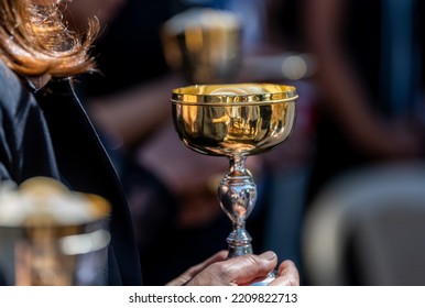 Woman At Church Holding Cup For Communion 