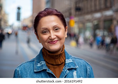 Woman in the city. Portrait of older woman smiling close up headshot