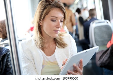 Woman In City Train Websurfing With Tablet