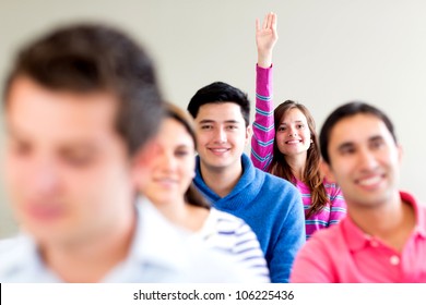 Woman In Class Raising Her Hand To Participate