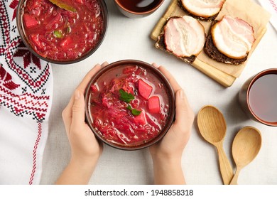 Woman With Clay Bowl Of Ukrainian Borsch At Table, Top View