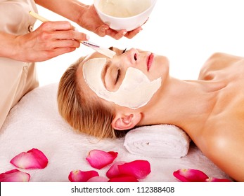 Woman With Clay Facial Mask With Rose Petal. Isolated.