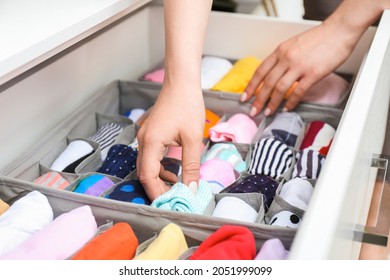 Woman with clean clothes in wardrobe