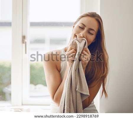 Woman, clean laundry smell and home or cleaning clothes, fabric or blanket with fragrance and happy housekeeping routine. Person, fresh linen and smelling scent of detergent product or soft clothing