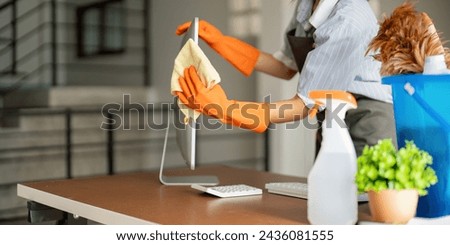Woman clean in office room at office. Housekeeper or maid cleaner feel happy wipe mop and clean the work desk. the office office cleaning staff