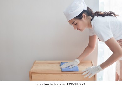 Woman Cleaner Cleaning Living Room In Apartment. Portrait Of Asian Woman Cleaning Staff Doing Housekeeping Or Domestic Helper Job. Young Adult Asian Woman Model