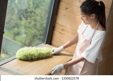 Woman Cleaner Cleaning Living Room In Apartment. Portrait Of Asian Woman Cleaning Staff Doing Housekeeping Or Domestic Helper Job. Young Adult Asian Woman Model