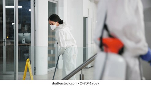 Woman, cleaner and mopping for hygiene, fresh and disinfectant for virus protection or housekeeping. People, worker and ppe suit for bacteria, disease and prevention in office as janitor for company - Powered by Shutterstock