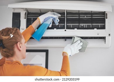 Woman Cleaning Aircon Filters Indoor Unit At Home.