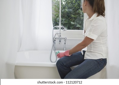 Woman Cleaning Bath Tub