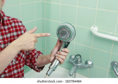 Woman Cleaning An Calcified Shower Head