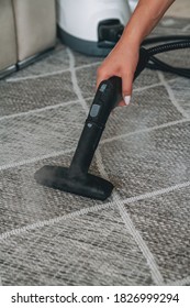 Woman Cleaning The Carpet With A Steam Cleaner