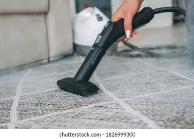 Woman Cleaning The Carpet With A Steam Cleaner