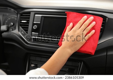 Woman cleaning center console with rag in car, closeup Imagine de stoc © 