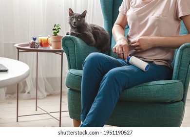 Woman Cleaning Clothes With Sticky Roller From Cats Hair, Cleaning Hair From Pets