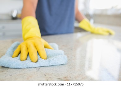 Woman Cleaning The Counter  In The Kitchen