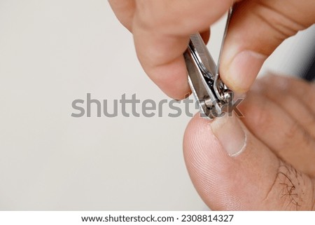 Woman is cleaning and cutting toenails