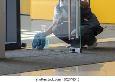 A Woman Cleaning The Door.