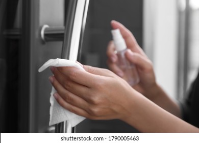 Woman cleaning door handle with wet wipe outdoors, closeup - Shutterstock ID 1790005463