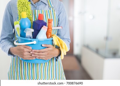 Woman With Cleaning Equipment Ready To Clean House On Bathroom Background