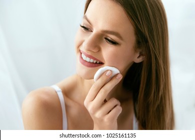 Woman Cleaning Face With White Pad. Beautiful Girl Removing Makeup White Cosmetic Cotton Pad. Happy Smiling Female Taking Off Makeup From Facial Skin With Cosmetic Pad. Face Skin Care. High Quality