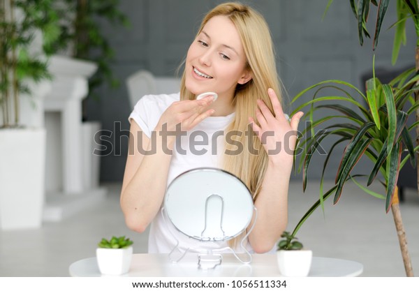 Woman Cleaning Face With White Pad. Beautiful\
Girl Removing Makeup White Cosmetic Cotton Pad. Happy Smiling\
Female Taking Off Makeup From Facial Skin With Cosmetic Pad. Face\
Skin Care. Home\
interior\
