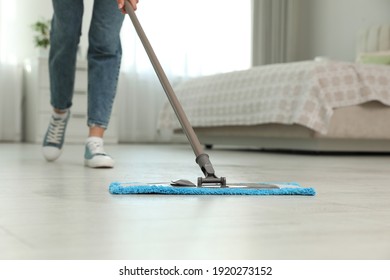 Woman Cleaning Floor With Mop At Home, Closeup