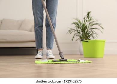 Woman Cleaning Floor With Mop At Home, Closeup