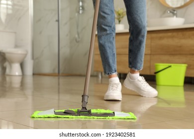 Woman Cleaning Floor With Mop At Home, Closeup